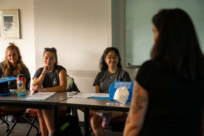 Students sit a table in classroom